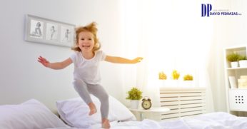 Happy Child Jumping on the Bed