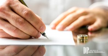 Man Signing on Paper With a Ring on the Table