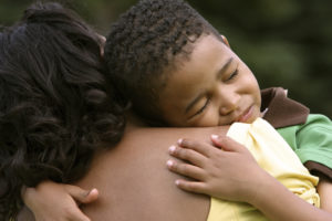 Young Boy Hugging Mother